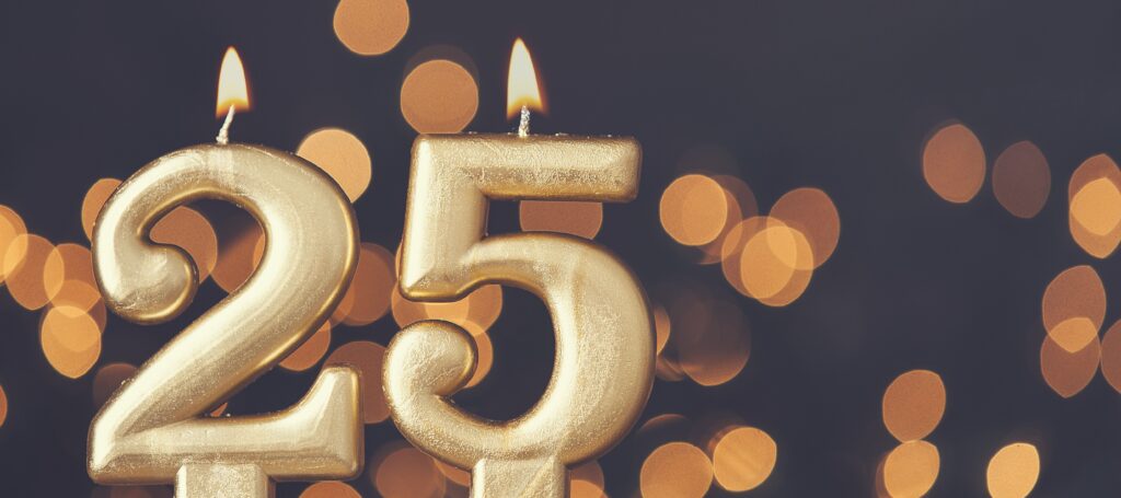 Gold number 25 celebration candle against blurred light background EDITO FEV