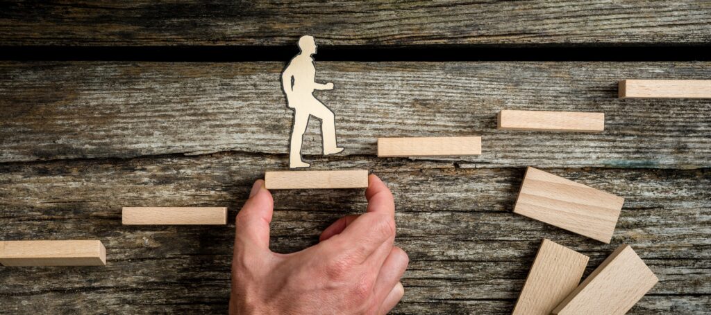 Teamwork concept with businessman holding up stairs CRISE